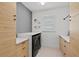 Well-organized laundry room with modern washer and dryer, custom cabinetry, and ample counter space at 8107 Slipway Dr, Sarasota, FL 34240