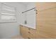 Bright laundry room with modern cabinets, sleek countertops, and a window with natural light at 8107 Slipway Dr, Sarasota, FL 34240