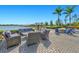Inviting outdoor lounge area with comfortable seating, a fire pit, and picturesque lake views, perfect for community gatherings at 8107 Slipway Dr, Sarasota, FL 34240