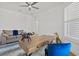 Bright office space with modern desk, blue velvet chair, neutral sofa, and stylish decor at 8107 Slipway Dr, Sarasota, FL 34240