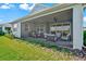 Inviting screened patio featuring cozy seating and dining areas, ideal for enjoying the serene backyard and water views at 8107 Slipway Dr, Sarasota, FL 34240