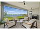 Covered patio with comfortable seating, ceiling fans, and a view of the lake at 8107 Slipway Dr, Sarasota, FL 34240
