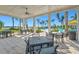 Inviting outdoor dining area with sleek tables and chairs overlooking the sparkling community pool at 8107 Slipway Dr, Sarasota, FL 34240
