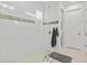 A walk-in shower features white tile walls with accent border, glass door, and tile floor at 8107 Slipway Dr, Sarasota, FL 34240