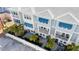 Townhome exterior featuring patios, balconies, awnings, landscaping, and fenced yard at 845 Burlington N Ave, St Petersburg, FL 33701
