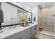 Bathroom with a double vanity, modern fixtures, tile surround shower with a glass door at 845 Burlington N Ave, St Petersburg, FL 33701