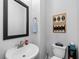 Powder room with a pedestal sink, decorative art, and a modern design at 845 Burlington N Ave, St Petersburg, FL 33701