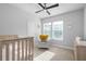 Bedroom with a ceiling fan, two windows with an abundance of natural light and a crib at 845 Burlington N Ave, St Petersburg, FL 33701
