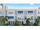 Beautiful townhome exteriors featuring blue awnings, private balconies, and lush tropical landscaping at 845 Burlington N Ave, St Petersburg, FL 33701