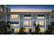 Beautiful townhome exteriors featuring blue awnings, private balconies, and lit windows at dusk at 845 Burlington N Ave, St Petersburg, FL 33701