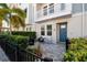 Inviting front porch with stone pavers, a blue door, and a cozy outdoor seating area at 845 Burlington N Ave, St Petersburg, FL 33701