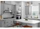 Modern kitchen with gray cabinets, stainless steel appliances, and bar stool seating at 845 Burlington N Ave, St Petersburg, FL 33701