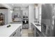 Well-lit kitchen showcases stainless appliances, gray cabinetry, and center island at 845 Burlington N Ave, St Petersburg, FL 33701