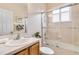 Bright bathroom featuring a bathtub with glass enclosure, shower head and a single sink at 10008 Sugar Mill Dr, Bradenton, FL 34212