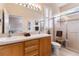 Spacious bathroom with double sinks, large mirror, and glass-enclosed shower with bench at 10008 Sugar Mill Dr, Bradenton, FL 34212