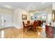 Elegant dining area with wood floors, a chandelier, and a mirrored wall at 10008 Sugar Mill Dr, Bradenton, FL 34212