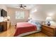 Cozy main bedroom featuring wood floors, a window and two bedside tables with lamps at 10008 Sugar Mill Dr, Bradenton, FL 34212