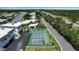 Aerial view of a community with waterfront access, a pool, and a basketball court at 10415 Waterbird Way # 10415, Bradenton, FL 34209