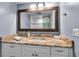 Bathroom features a vanity with marble countertop and modern lighting at 10415 Waterbird Way # 10415, Bradenton, FL 34209
