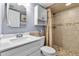 Bathroom featuring a white vanity, tiled shower, and decorative seashell accents at 10415 Waterbird Way # 10415, Bradenton, FL 34209