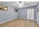 This cozy bedroom features light blue walls, wood-look floors, and a ceiling fan at 10415 Waterbird Way # 10415, Bradenton, FL 34209