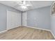 Bedroom with white walls and light-colored wood-look floors features a closet with bi-fold doors at 10415 Waterbird Way # 10415, Bradenton, FL 34209