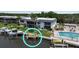 Aerial view of waterfront condos, boat dock, and shared community swimming pool at 10415 Waterbird Way # 10415, Bradenton, FL 34209