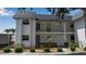 Exterior view of a well-maintained two-story condominium with mature landscaping at 10415 Waterbird Way # 10415, Bradenton, FL 34209