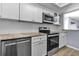 Stylish kitchen featuring white cabinetry, stainless steel appliances, and granite countertops at 10415 Waterbird Way # 10415, Bradenton, FL 34209