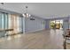 Spacious living room with wood-look flooring, natural light, and a slider to a lanai at 10415 Waterbird Way # 10415, Bradenton, FL 34209