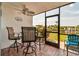 Screened-in patio with canal views, table and chairs at 10415 Waterbird Way # 10415, Bradenton, FL 34209