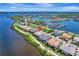 Beautiful aerial view of waterfront homes with a marina, a river, and a neighborhood pool at 1264 Riverscape St # B, Bradenton, FL 34208