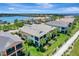 Aerial view of waterfront homes featuring landscaping and a glimpse of a river and boat docks at 1264 Riverscape St # B, Bradenton, FL 34208