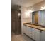 Bathroom featuring granite countertops, dual sinks, ample vanity storage, and glass-enclosed shower at 1264 Riverscape St # B, Bradenton, FL 34208
