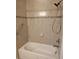 Tiled bathtub and shower combination with safety grab bar in this updated bathroom at 1264 Riverscape St # B, Bradenton, FL 34208