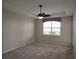 Cozy bedroom featuring neutral carpeting, ceiling fan, and bright window at 1264 Riverscape St # B, Bradenton, FL 34208