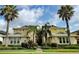 Two story yellow and cream building with manicured landscaping and palm trees around the building at 1264 Riverscape St # B, Bradenton, FL 34208