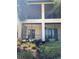 Exterior view of enclosed lanais, landscaping, and nearby palm trees at 1264 Riverscape St # B, Bradenton, FL 34208