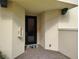 Close up of the front door, walls, and fire extinguisher box on an exterior entryway at 1264 Riverscape St # B, Bradenton, FL 34208