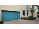 Exterior shot of a teal garage door with two windows and minimal landscaping at 1264 Riverscape St # B, Bradenton, FL 34208