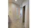 Hallway with neutral paint, tile floors, linen closet and doorways at 1264 Riverscape St # B, Bradenton, FL 34208