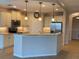 Well-lit kitchen features stainless steel appliances, granite countertops, and island with breakfast bar seating at 1264 Riverscape St # B, Bradenton, FL 34208