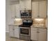 Updated kitchen with stainless appliances, granite countertops, tiled backsplash, and ample cabinet space at 1264 Riverscape St # B, Bradenton, FL 34208