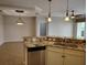 Granite countertops add style to this well-equipped kitchen with stainless steel dishwasher and undermount sink at 1264 Riverscape St # B, Bradenton, FL 34208