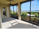 Relaxing screened lanai with scenic water views, ceiling fan, and lush landscaping at 1264 Riverscape St # B, Bradenton, FL 34208