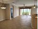 Open living room boasts tile floors, natural light, and access to a patio with water views at 1264 Riverscape St # B, Bradenton, FL 34208