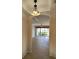 Open living room with tiled floor, ceiling fan, and access to a patio with a water view at 1264 Riverscape St # B, Bradenton, FL 34208