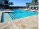Community pool with easy access entry, sun loungers, and nearby residential buildings at 1264 Riverscape St # B, Bradenton, FL 34208