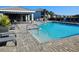 Community pool featuring a ramp entry, sun loungers, and a nearby outdoor cooking area at 1264 Riverscape St # B, Bradenton, FL 34208