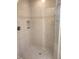 Walk-in shower featuring decorative tile accents, shower head and seat at 1264 Riverscape St # B, Bradenton, FL 34208
